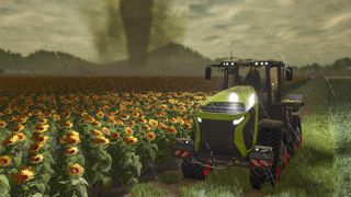 Green tractor near burning sunflower fields