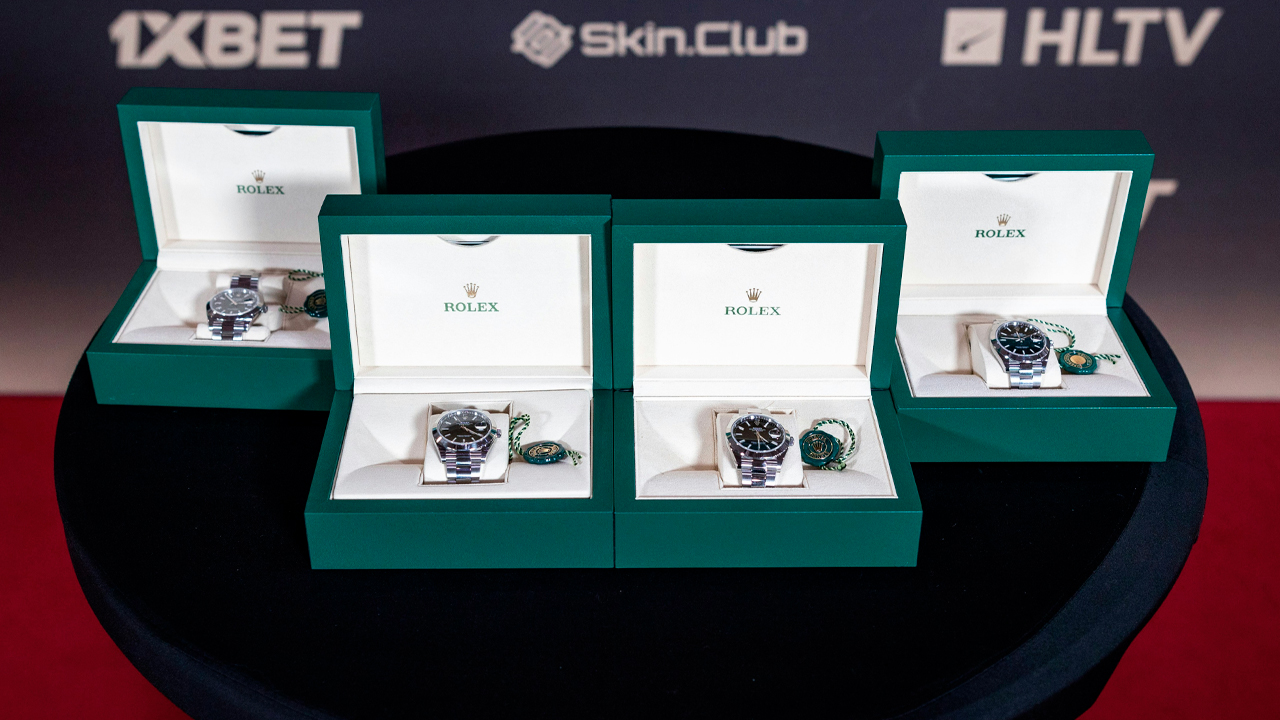 Four Rolex watches in green boxes