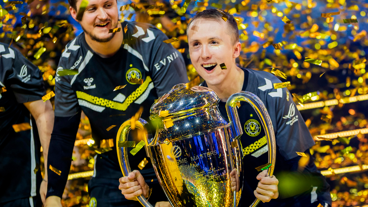 Two men celebrate with trophy